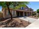 Inviting two-story home with covered porch, well-manicured landscaping, and a long driveway at 12601 W San Miguel Ave, Litchfield Park, AZ 85340