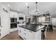 Bright kitchen with white cabinets, a large island with a black countertop, and a bar area at 12601 W San Miguel Ave, Litchfield Park, AZ 85340
