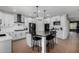 Eat-in kitchen featuring white cabinets, stainless appliances, an island, and a breakfast bar at 12601 W San Miguel Ave, Litchfield Park, AZ 85340