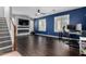 Upstairs living room with mounted television and a blue accent wall at 12601 W San Miguel Ave, Litchfield Park, AZ 85340