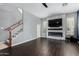 Cozy living room with an electric fireplace, staircase, and tile flooring at 12601 W San Miguel Ave, Litchfield Park, AZ 85340