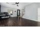 Open concept living room with hardwood floors, ceiling fan, and staircase at 12601 W San Miguel Ave, Litchfield Park, AZ 85340
