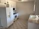 Bright kitchen with white appliances and tile flooring at 13603 N 111Th Ave, Sun City, AZ 85351