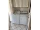 Laundry room with stacked white washer and dryer at 13603 N 111Th Ave, Sun City, AZ 85351