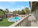 Relaxing backyard featuring a sparkling pool, lush green lawn, and mature palm trees at 1406 E Jasper Dr, Chandler, AZ 85225