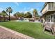 Spacious backyard with lush grass, a sparkling pool, and a patio area perfect for entertaining at 1406 E Jasper Dr, Chandler, AZ 85225