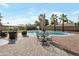 Inviting backyard featuring a refreshing pool, outdoor seating, and mature palm trees for a perfect oasis at 1406 E Jasper Dr, Chandler, AZ 85225