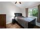 Cozy bedroom with hardwood floors, ceiling fan, and natural light from window at 1406 E Jasper Dr, Chandler, AZ 85225