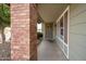 Covered front porch featuring a charming door with decorative wreath and brick pillar at 1406 E Jasper Dr, Chandler, AZ 85225