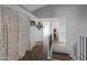 Hallway features hardwood floors, a closet with curtain, and staircase at 1406 E Jasper Dr, Chandler, AZ 85225