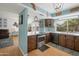 Open-concept kitchen featuring custom cabinets, a breakfast bar, and stainless steel appliances at 1406 E Jasper Dr, Chandler, AZ 85225