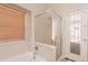 Bright bathroom with a garden tub, shower, and wood blinds at 15128 W Melissa Ln, Surprise, AZ 85374