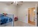 A bedroom with a ceiling fan, closet, and window at 15128 W Melissa Ln, Surprise, AZ 85374
