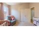 A Bedroom with a crib, chair, and closet at 15128 W Melissa Ln, Surprise, AZ 85374