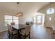 Bright dining room with modern light fixture and large window; seamlessly connects to living area at 15128 W Melissa Ln, Surprise, AZ 85374