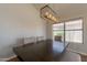 Dining room showcasing a dark wood table, seating, and modern light fixture, perfect for Gathering gatherings at 15128 W Melissa Ln, Surprise, AZ 85374