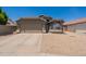 Charming single-story home featuring a two-car garage and desert landscaping at 15128 W Melissa Ln, Surprise, AZ 85374