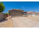 Charming single-story home featuring a two-car garage and desert landscaping at 15128 W Melissa Ln, Surprise, AZ 85374