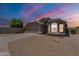 Charming single-story home featuring a two-car garage, gravel landscaping, and neutral-toned exterior paint at 15128 W Melissa Ln, Surprise, AZ 85374