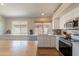 Bright kitchen featuring wood-top island and white cabinets at 15128 W Melissa Ln, Surprise, AZ 85374