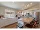 Well-lit kitchen boasts white cabinets, stainless steel appliances, and an island with bar seating at 15128 W Melissa Ln, Surprise, AZ 85374