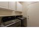 A laundry room with a washer, dryer, and cabinets at 15128 W Melissa Ln, Surprise, AZ 85374