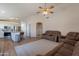 Open living space with kitchen, sofas, and wood flooring at 15128 W Melissa Ln, Surprise, AZ 85374