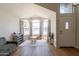 Bright living room featuring large windows and hardwood floors at 15128 W Melissa Ln, Surprise, AZ 85374