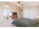 Spacious primary bedroom featuring walk-in closet, tv, and neutral carpet at 15128 W Melissa Ln, Surprise, AZ 85374