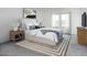 Serene bedroom with a large bed, neutral tones, and ample natural light, creating a calming retreat at 15511 W Deanne Dr, Waddell, AZ 85355