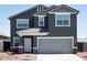 Charming two-story home featuring a two-car garage and classic architectural details at 15511 W Deanne Dr, Waddell, AZ 85355