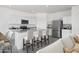 Modern kitchen featuring white cabinets, stainless steel appliances, a granite countertop island, and barstool seating at 15511 W Deanne Dr, Waddell, AZ 85355