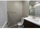 Well-lit half bathroom with modern vanity and mirror at 17493 W Fulton St, Goodyear, AZ 85338
