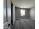 Comfortable bedroom boasting neutral walls, carpet flooring and a sliding door closet for easy access at 17493 W Fulton St, Goodyear, AZ 85338