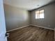 A well-lit bedroom features hard surface floors, a large window, and fresh paint at 17493 W Fulton St, Goodyear, AZ 85338