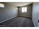 Bright bedroom featuring neutral walls, carpet flooring and a window allowing for abundant natural light at 17493 W Fulton St, Goodyear, AZ 85338