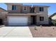 Inviting two-story home featuring a neutral color scheme, attached two-car garage, and low maintenance landscaping at 17493 W Fulton St, Goodyear, AZ 85338