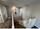 Carpeted staircase with white railing leads to the upper level with bright lighting and neutral walls at 17493 W Fulton St, Goodyear, AZ 85338