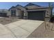Charming single-story home featuring a stone facade, neutral colors, and a spacious two-car garage at 17738 W Onyx Ave, Waddell, AZ 85355
