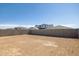 Expansive backyard with privacy block wall, offering a blank canvas for landscaping and outdoor activities at 17778 W Turquoise Ave, Waddell, AZ 85355