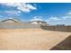 Spacious backyard featuring block fence with clear blue skies above at 17778 W Turquoise Ave, Waddell, AZ 85355
