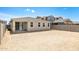 Home with sliding glass door leading to backyard surrounded by block wall at 17778 W Turquoise Ave, Waddell, AZ 85355