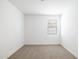A small bedroom featuring a neutral carpet and a window at 17778 W Turquoise Ave, Waddell, AZ 85355