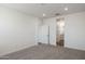 Spacious bedroom featuring neutral carpet, recessed lighting, and ensuite bathroom entrance at 17778 W Turquoise Ave, Waddell, AZ 85355