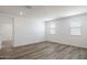Minimalist bedroom features neutral carpet, recessed lighting, and two bright, view-framing windows at 17778 W Turquoise Ave, Waddell, AZ 85355