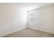 Small bedroom with a neutral carpet and a window overlooking neighborhood at 17778 W Turquoise Ave, Waddell, AZ 85355
