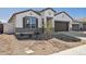Charming single-Gathering home with a well-manicured front yard and a two-car garage, showcasing modern architecture at 17778 W Turquoise Ave, Waddell, AZ 85355