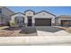 Charming single-Gathering home with a well-manicured front yard and a two-car garage, showcasing modern architecture at 17778 W Turquoise Ave, Waddell, AZ 85355