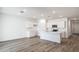 Bright kitchen features an island, stainless appliances, white cabinets, and wood-look floors at 17778 W Turquoise Ave, Waddell, AZ 85355