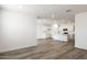 Open-concept living space featuring wood-look flooring and a modern kitchen with an island at 17778 W Turquoise Ave, Waddell, AZ 85355